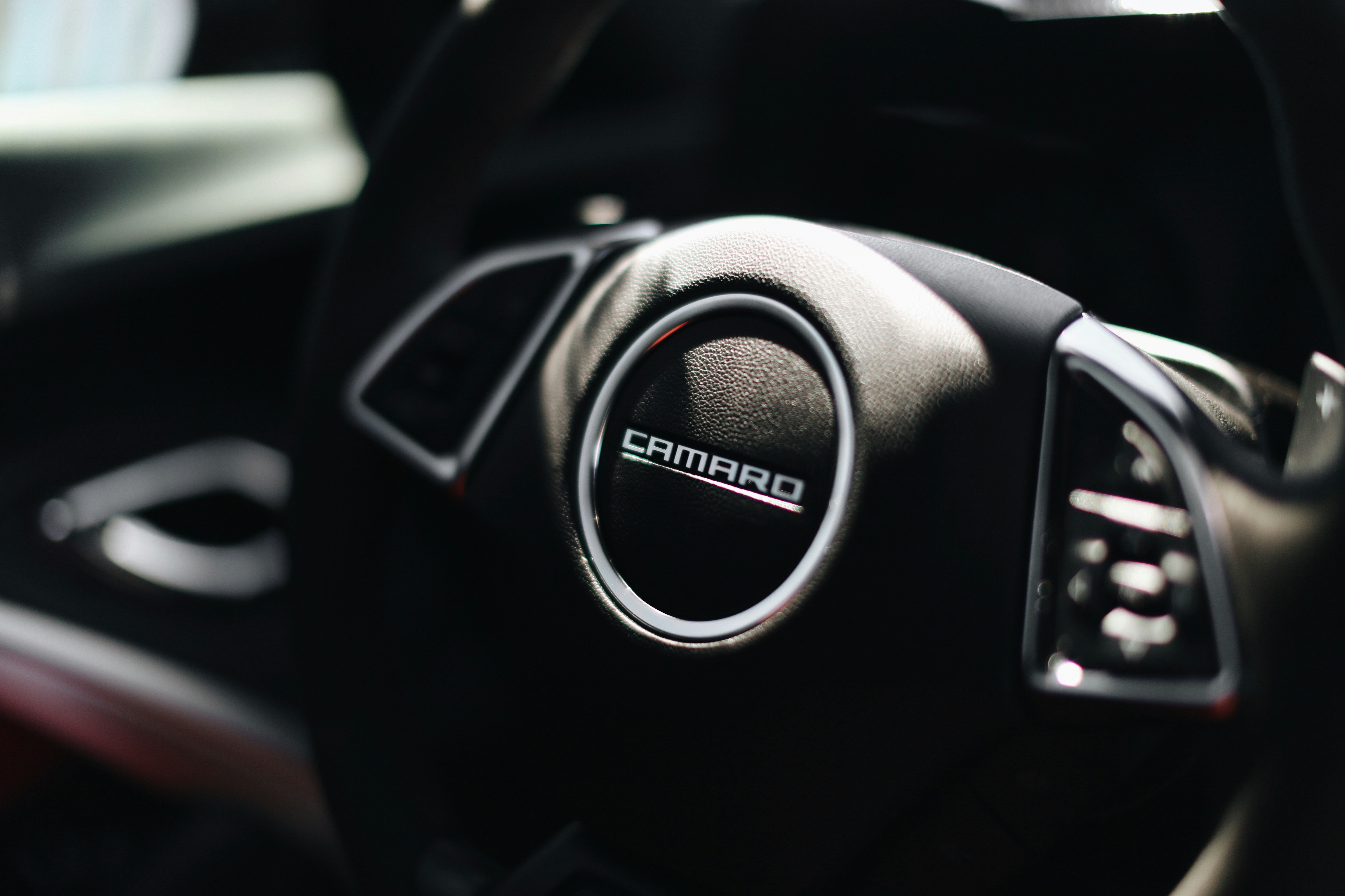 black and silver nissan steering wheel